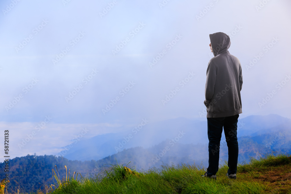 Teenager asian boy standing at mountain