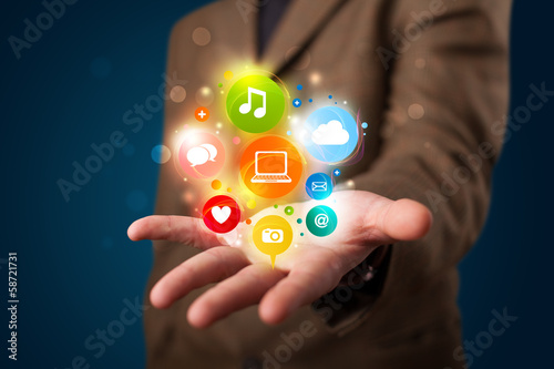 Young businessman presenting colorful technology icons and symbo