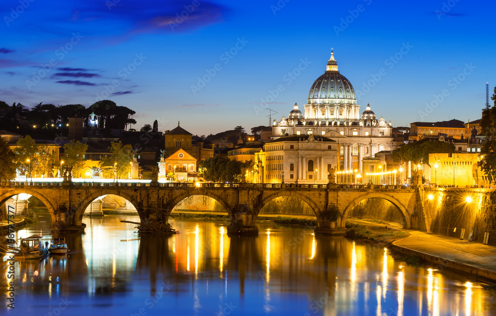 Night view of Basilica St Peter and river Tiber in Rome in Italy