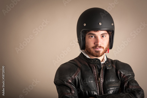 Portrait of confident young man with leather jacket and helmet © pio3