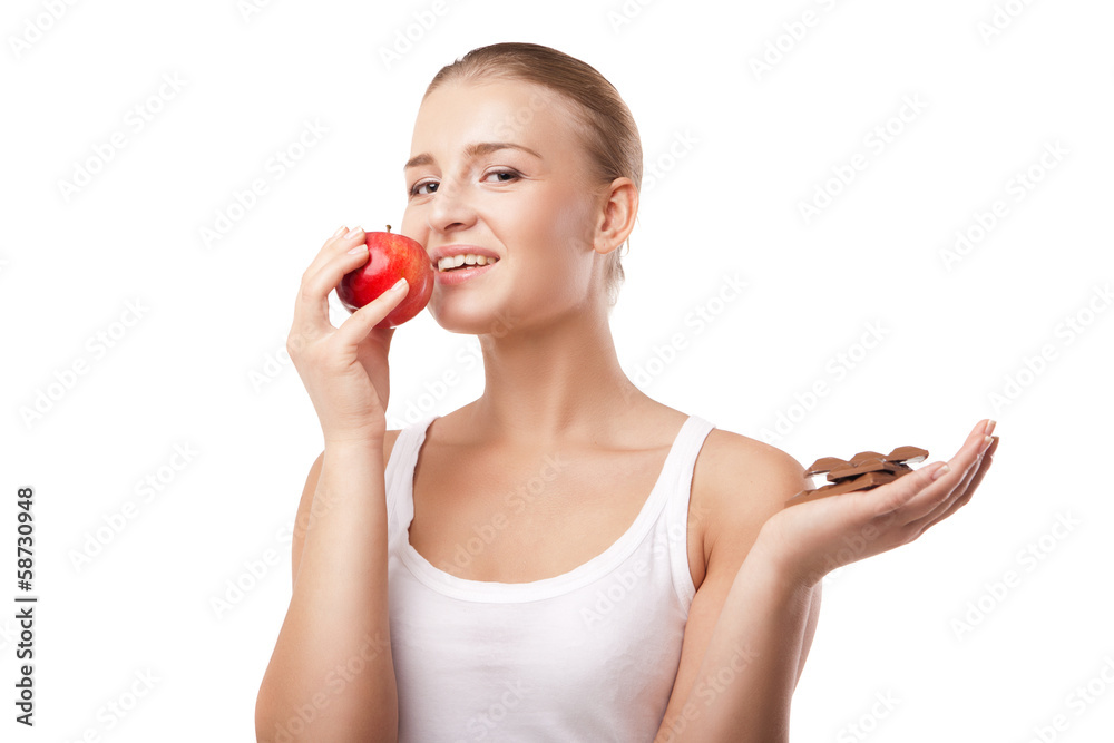 Woman holding apple and chocolate isolated Woman holding apple and chocolate isolated