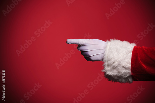 Santa Claus gloved hand pointing finger