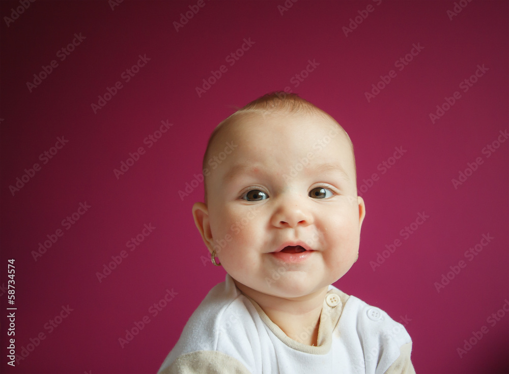 Portrait of a 9 month baby girl on a blue painted background Portrait of a 9 month baby girl on a blue painted background