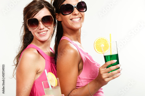 two girls with a drink, isolated on white