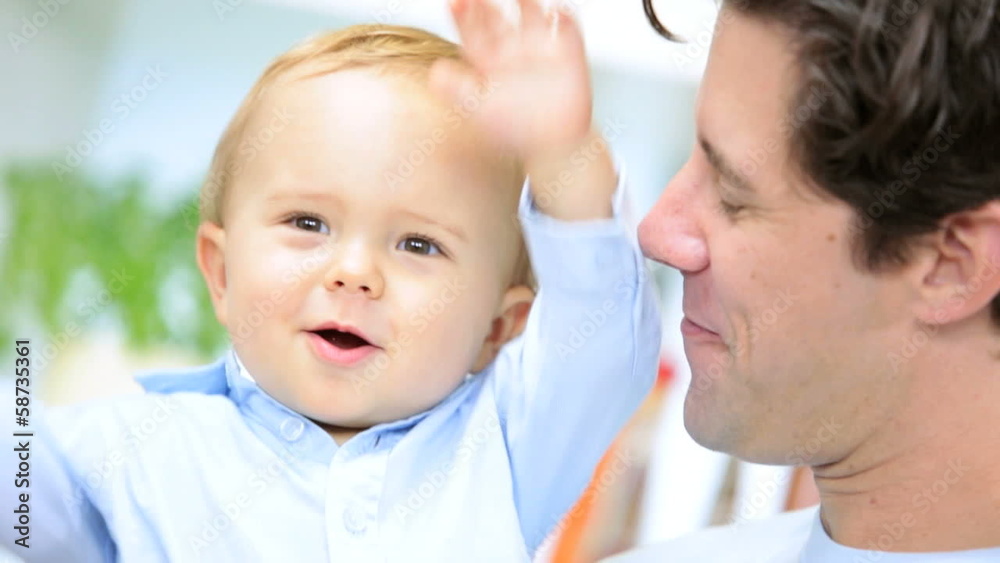Young Caucasian Father Holding Son Home Kitchen Close Up Young Caucasian Father Holding Son Home Kitchen Close Up
