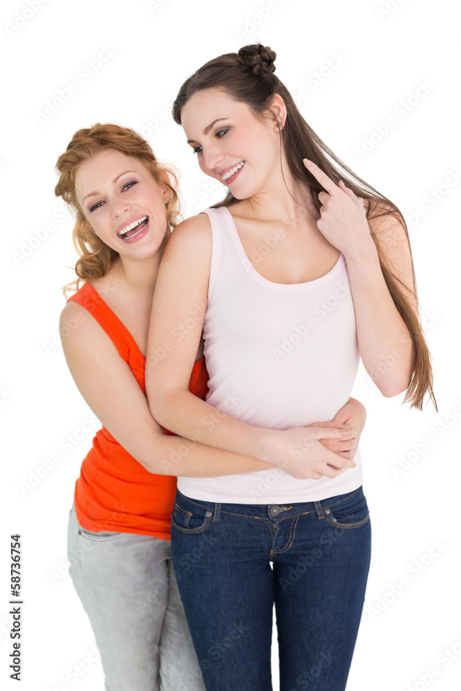Cheerful female embracing her friend from behind Cheerful female embracing her friend from behind