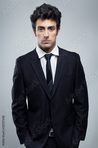 Young confident Businessman looking at camera