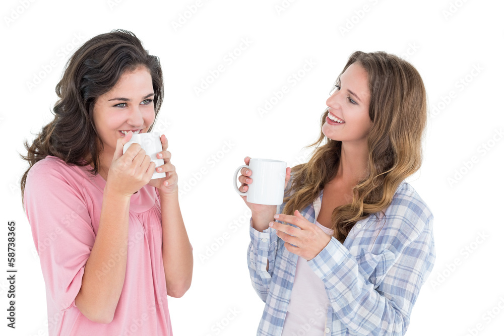 Two smiling young female friends drinking coffee Two smiling young female friends drinking coffee