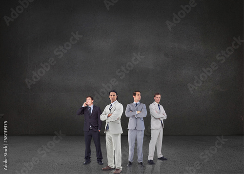 Composite image of businessmen standing arms crossed