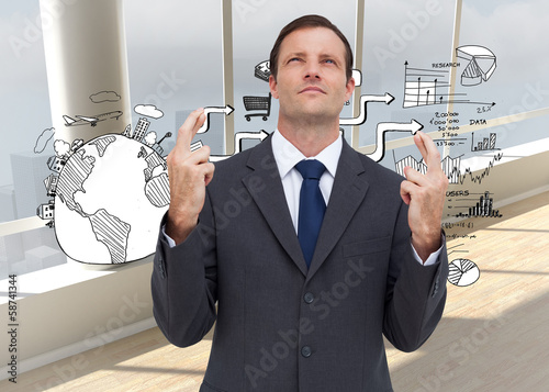 Composite image of serious businessman with fingers crossed is l photo