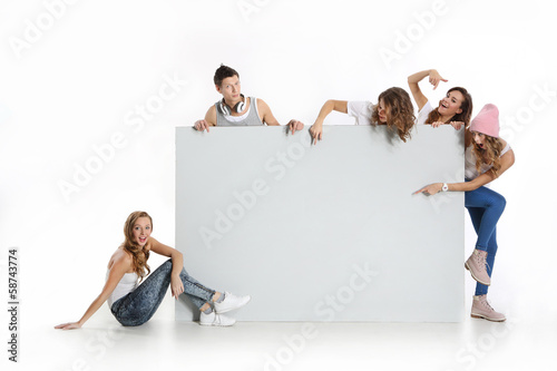 Grupa młodych ludzi trzyma  pusta białą tablicę