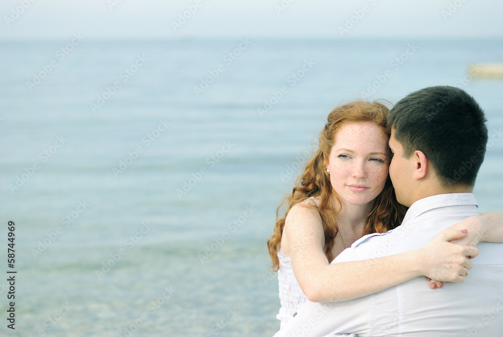 beautiful young couple in love near the sea