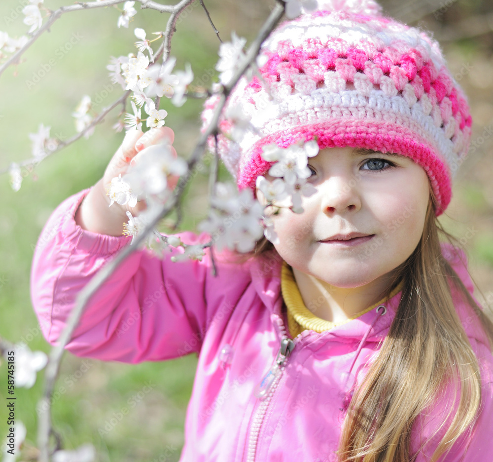 beautiful little girl near a flowering tree beautiful little girl near a flowering tree