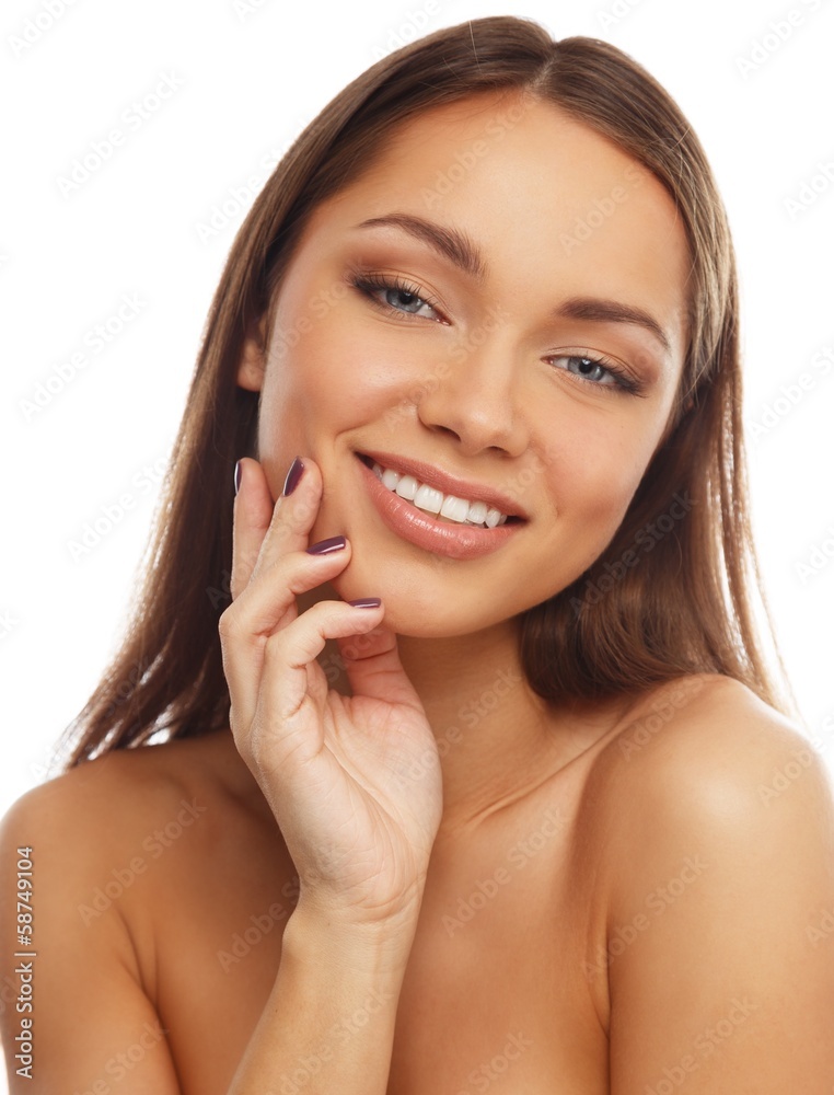Young smiling brunette girl touching her face Young smiling brunette girl touching her face