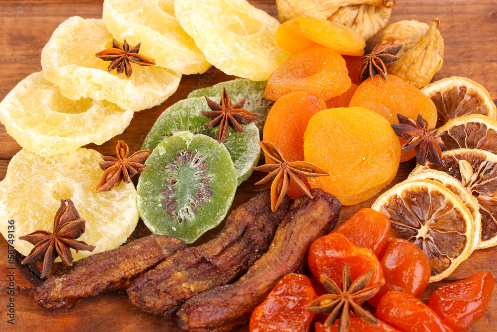 Dried fruits with anise stars on wooden background