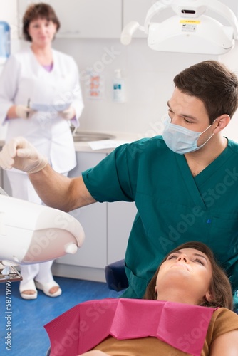 Young woman and man doctor at dentist s surgery