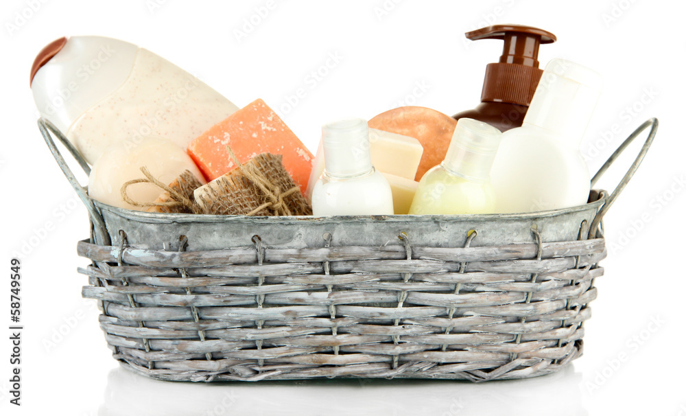 Composition of cosmetic bottles and soap in basket, isolated