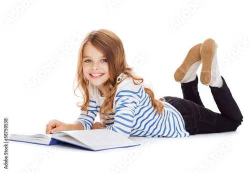 smiling little student girl lying on the floor