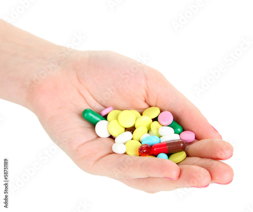 Pills in hand isolated on white