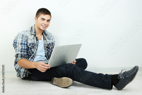 Guy sitting on floor in room