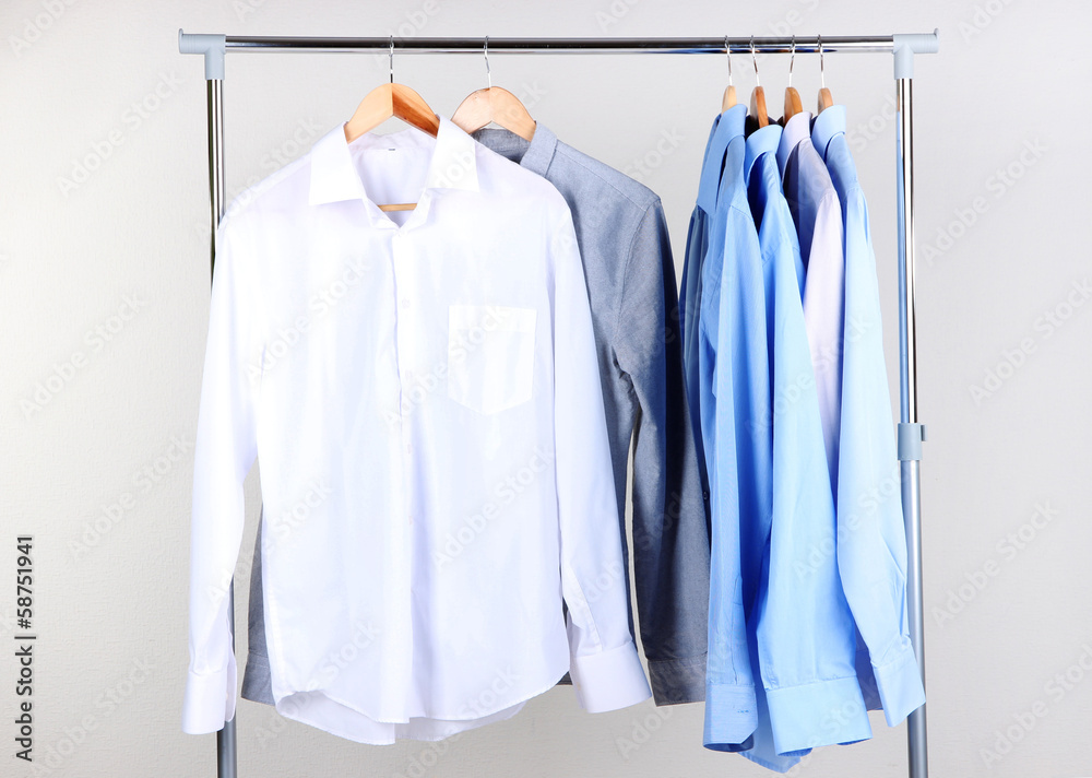 Office male clothes on hangers, on gray background Office male clothes on hangers, on gray background