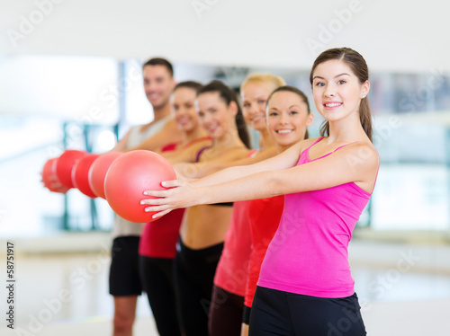group of smiling people working out with ball © Syda Productions