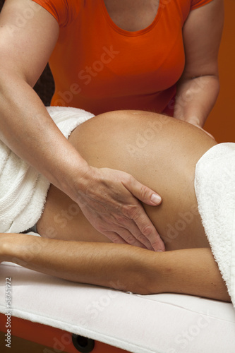 Young pregnant woman receiving relaxing massage