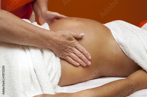 Young pregnant woman receiving relaxing massage