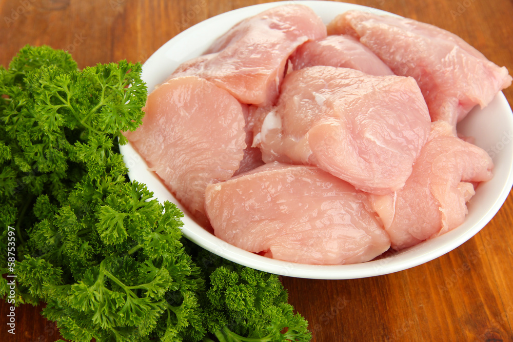 Raw turkey meat on wooden table close up Raw turkey meat on wooden table close up