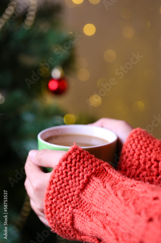 Hands holding mug of hot drink, close-up,