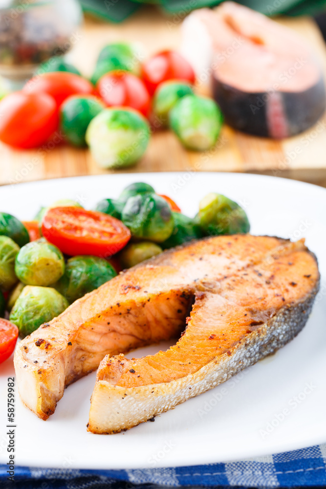 Salmon with roasted brussels sprout and tomato