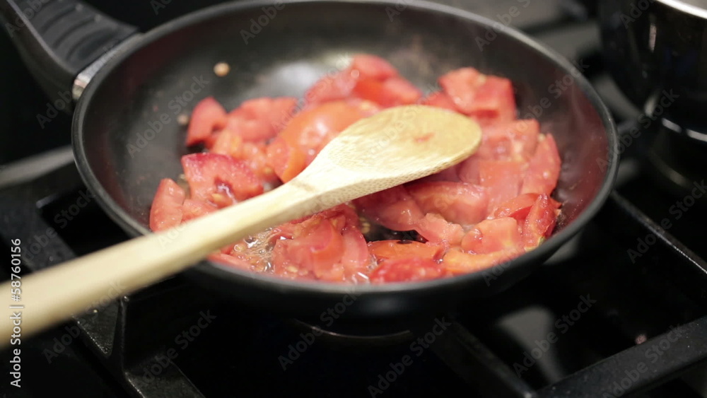 Frying chopped tomatoes on frying pan Frying chopped tomatoes on frying pan