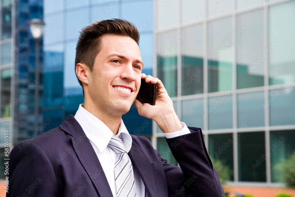 Portrait of a young businessman talking on the phone Portrait of a young businessman talking on the phone