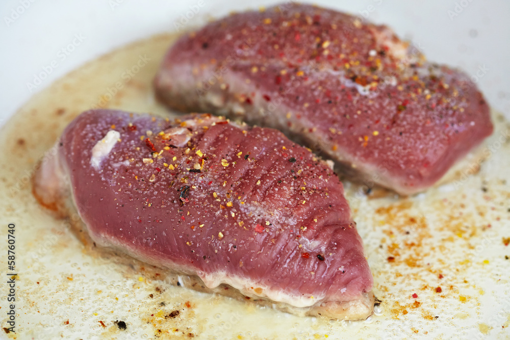 Duck breast being fried in pan Duck breast being fried in pan