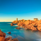 Ploumanach lighthouse sunset in pink granite coast, Brittany, Fr