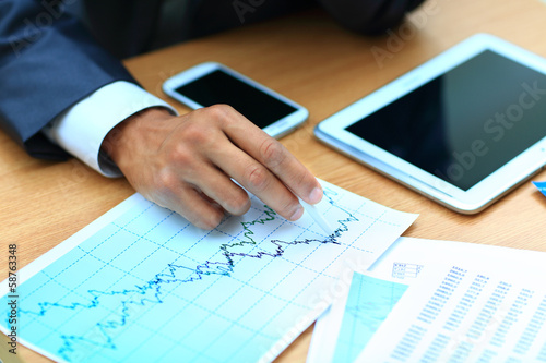 Young businessman working with modern devices