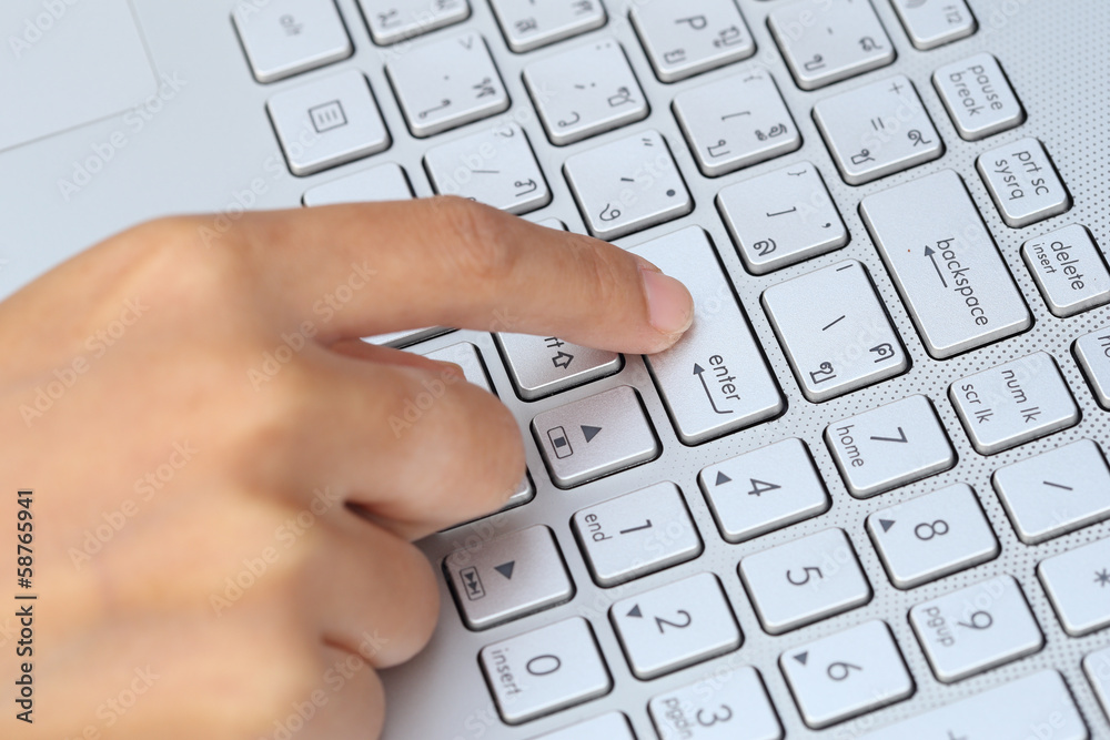 finger pushing the button of keyboard finger pushing the button of keyboard
