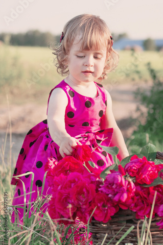 little girl with flowers outdoor photo