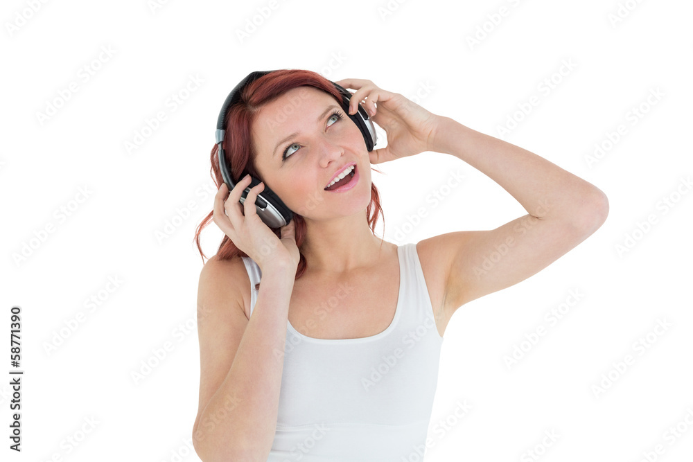 Casual woman enjoying music through headphones Casual woman enjoying music through headphones