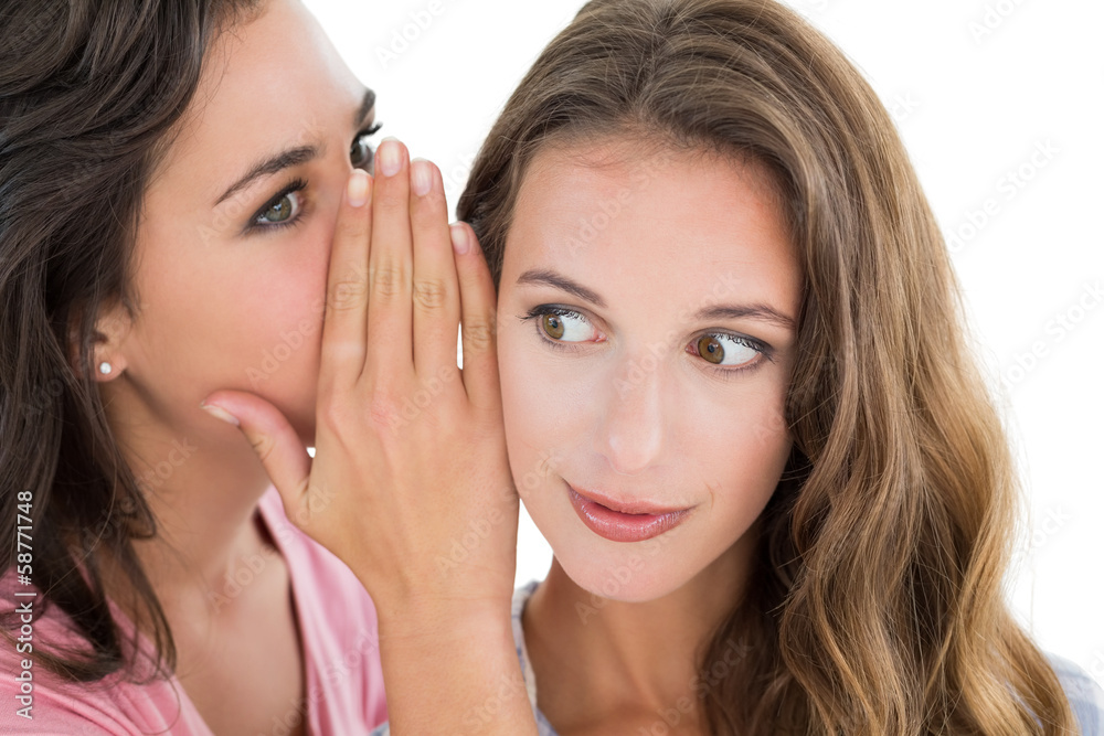 Two young female friends gossiping Two young female friends gossiping