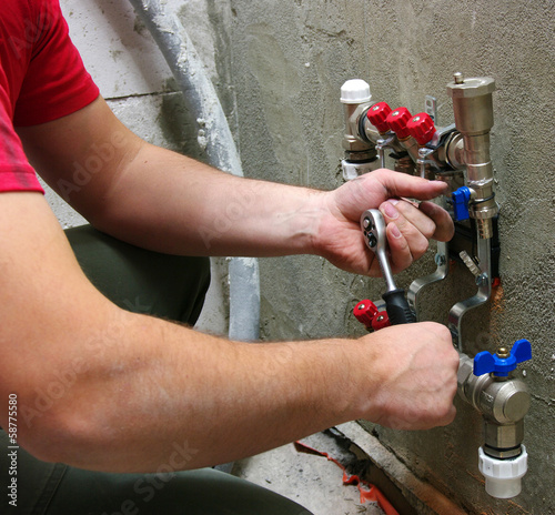 Plumber installing pipes