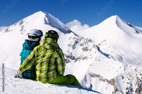 young couple enjoying winter mountains photo