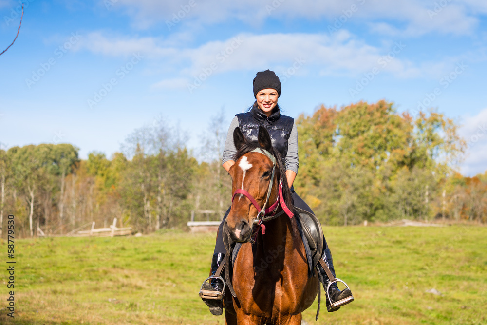 Elegant attractive woman riding a horse Elegant attractive woman riding a horse