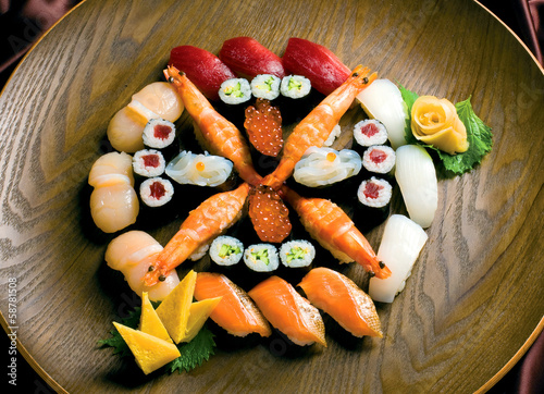 Sushi rolls on a wood plate