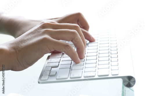 Image of female hands typing on keyboard