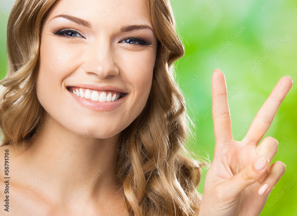Woman, showing two fingers or victory gesture Woman, showing two fingers or victory gesture