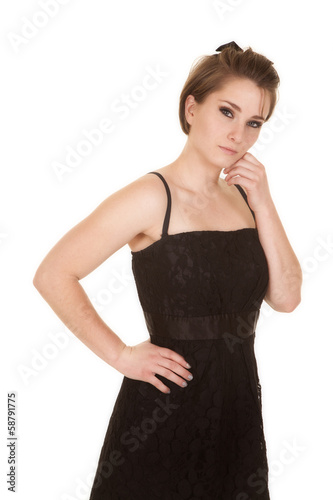 woman in black dress hand on chin