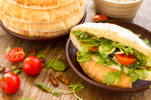 Pita with tomatos, cheese and salad mix
