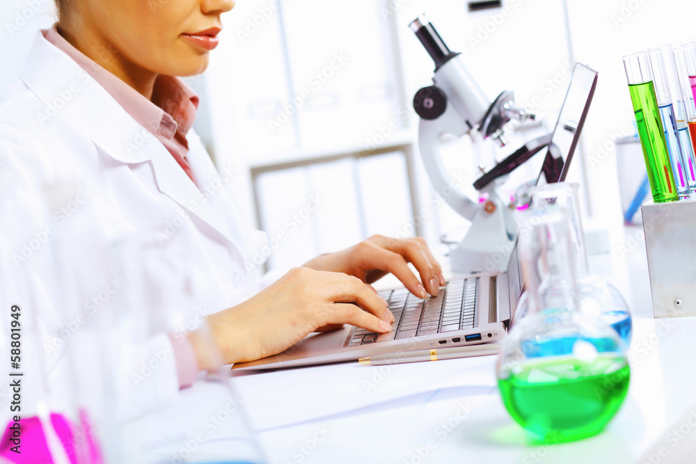 Fototapeta premium Young female scientist working in laboratory
