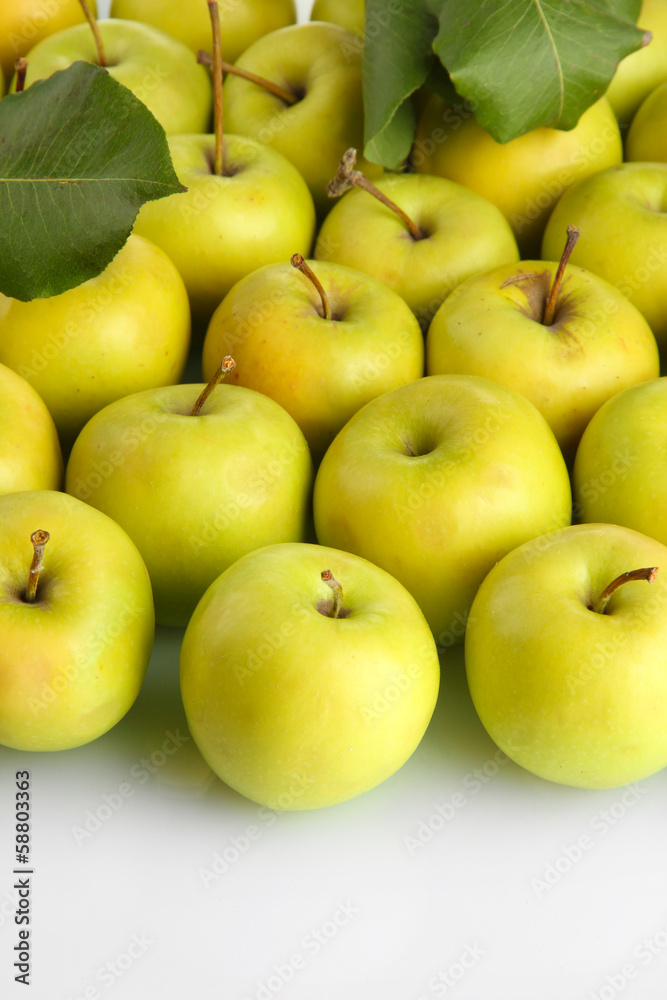 juicy apples with green leaves, isolated on white juicy apples with green leaves, isolated on white